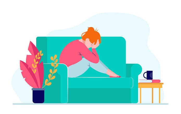 Therapy not working Lady sat on sofa with head between hands.